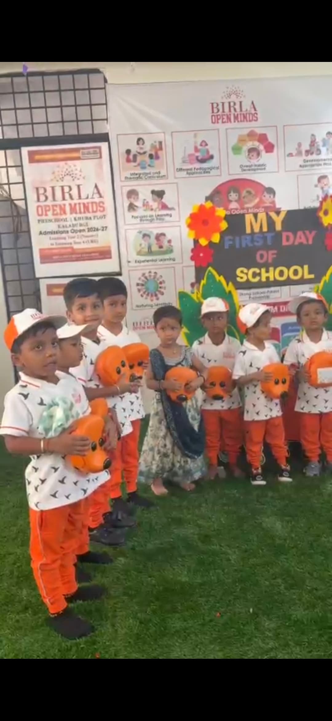 A line of children celebrating their first day of school at the Khuba Plot campus.
