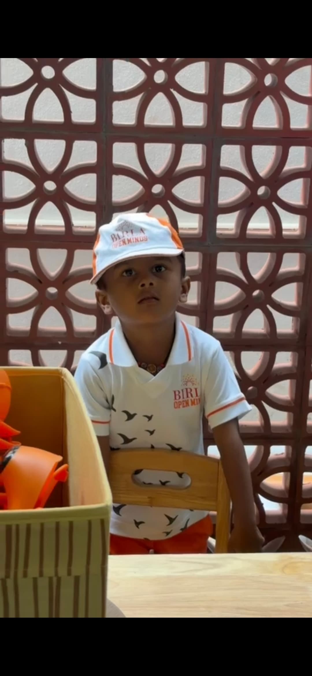 A young student in the Birla Open Minds uniform during a classroom activity.
