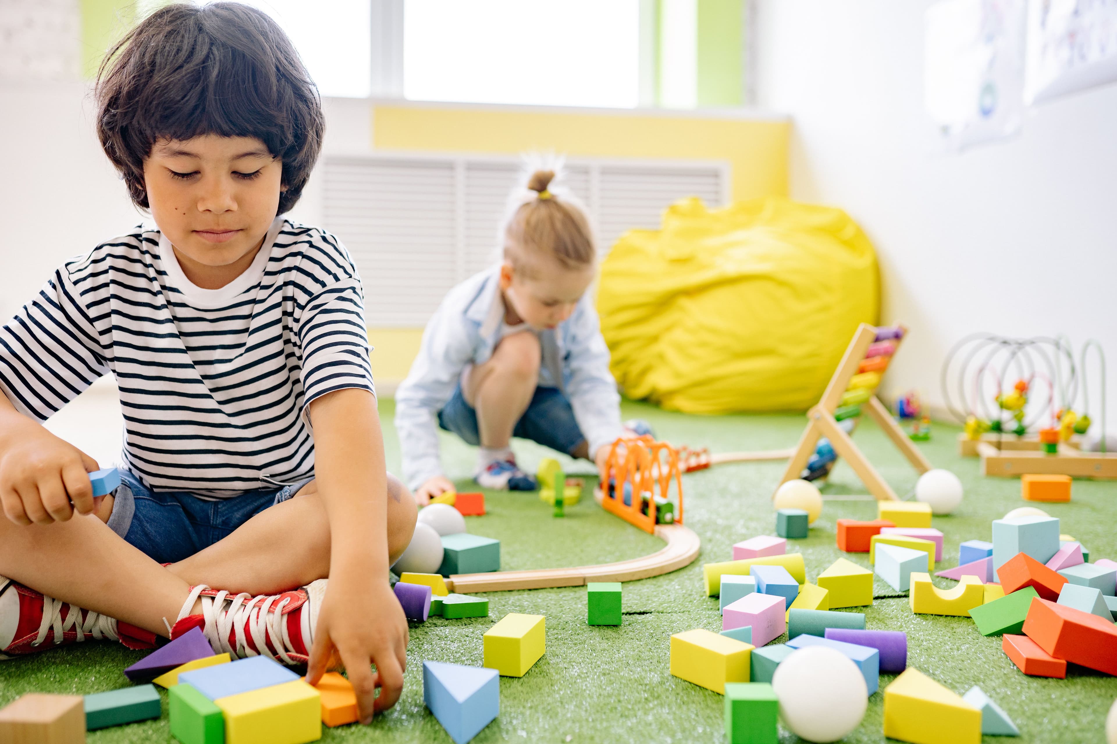 A teacher guiding young children through a hands-on learning activity.